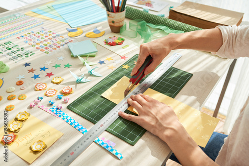 Creative Woman Concentrated on Scrapbooking