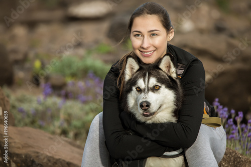 Content sportive girl hugging dog