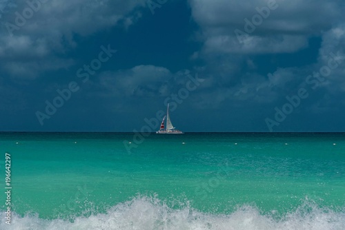 white beach with with sailboats in the ocean in the Caribbean sea Island of Aruba