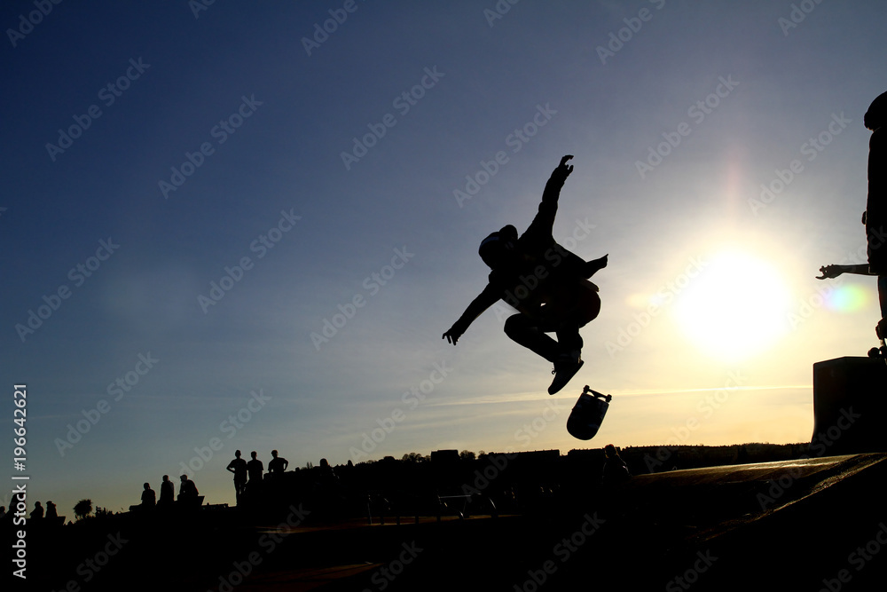 Skateboarder performing an aerial skateboarding jump trick Skateboarder performing an aerial skateboarding jump trick