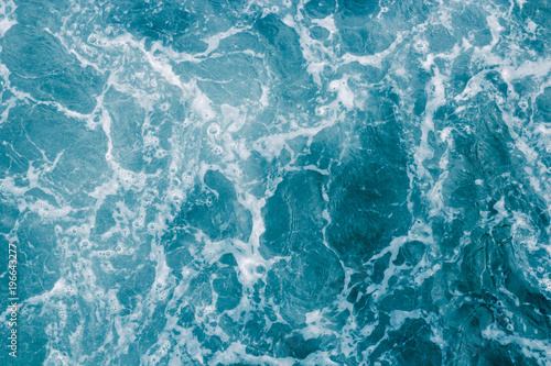 Abstract blue sea water with white foam and bubbles for background, nature background concept