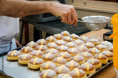 Photography sprinkle the pastry with powdered sugar through a sieve