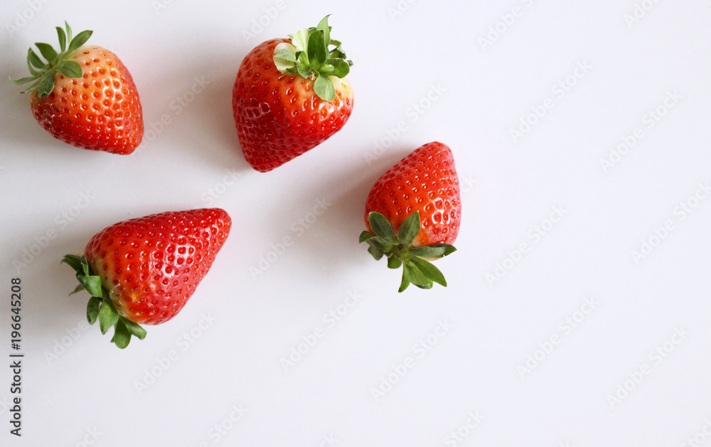 Food background .Closeup on a freshly organic red ripe strawberries lying on a white background.Summer ripe berries.Delicious fruit. Space for text in corner .Blurred background. Food background .Closeup on a freshly organic red ripe strawberries lying on a white background.Summer ripe berries.Delicious fruit. Space for text in corner .Blurred background.