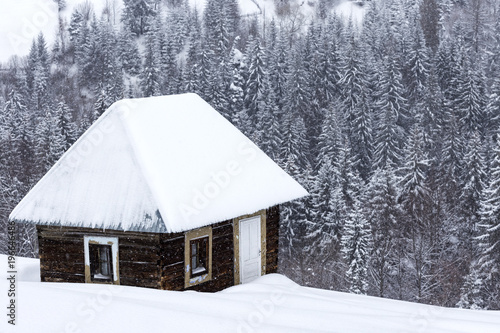 Little wooden houses on Romanian mountains at winter © Sebastian Studio