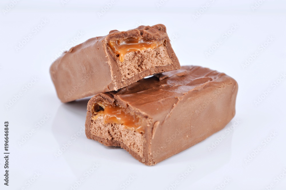 Closeup of chocolate bar on white background. Selective focus. Closeup of chocolate bar on white background. Selective focus.