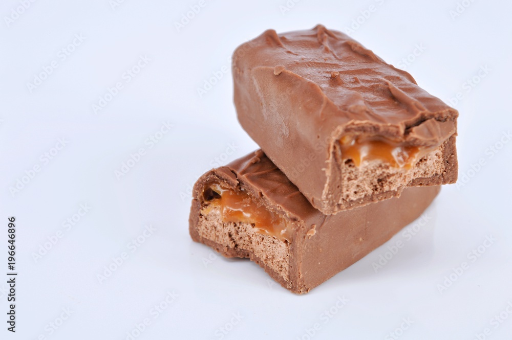 Closeup of chocolate bar on white background. Selective focus. Closeup of chocolate bar on white background. Selective focus.