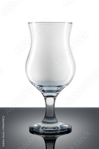 Empty hurricane cocktail glass isolated on white background