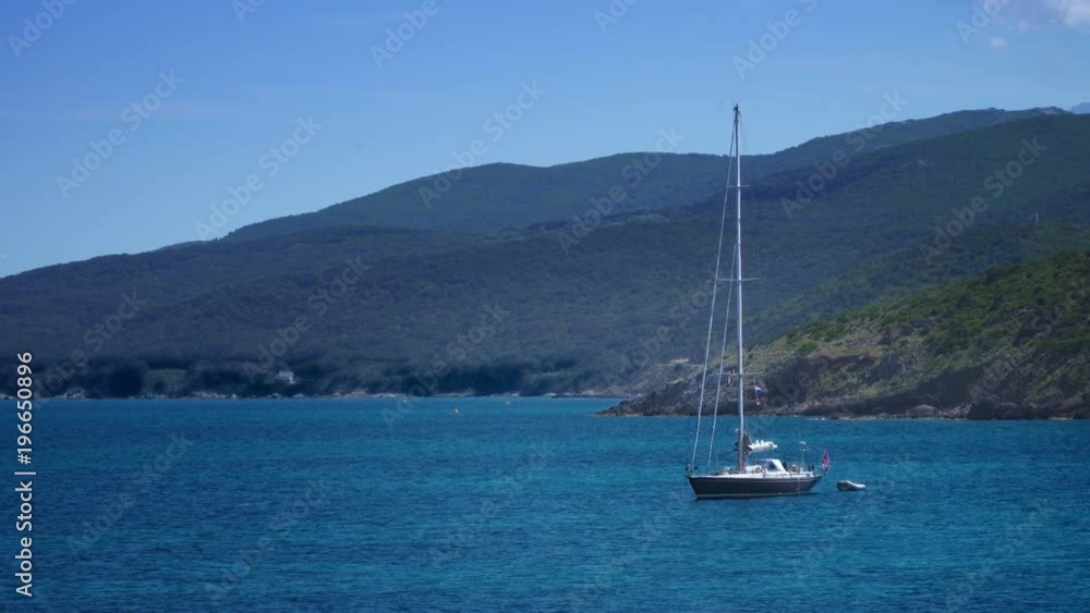 4K Sail boat in a crystal clear bay. Holiday vacation by the sea 4K Sail boat in a crystal clear bay. Holiday vacation by the sea