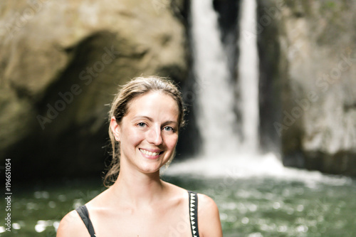 girl enjoying vacation and exploring beautiful waterfall © Louis-Photo