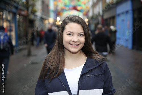 Beautiful Asian Woman Portrait Outdoors with Brown Hair Smiling 
