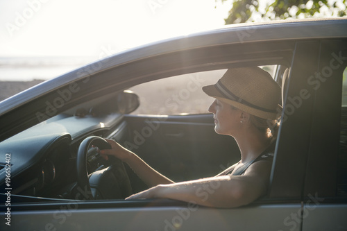 woman sitting in a rental car on holiday vacancy photo