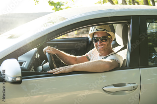 Men sitting in a rental car on holiday vacancy photo