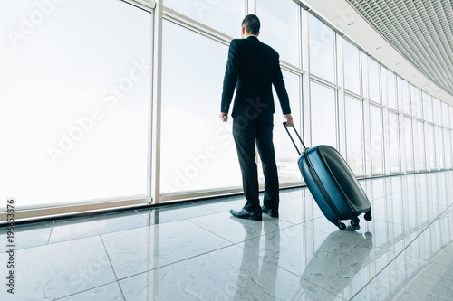 Wallpaper Mural Business man at international airport moving to terminal gate for airplane travel trip. Mobility concept and aerospace industry flight connections. Torontodigital.ca