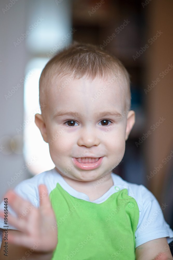 Funny little boy showing emotions, laughing. Caucasian child 2 years old. Closeup portriat.