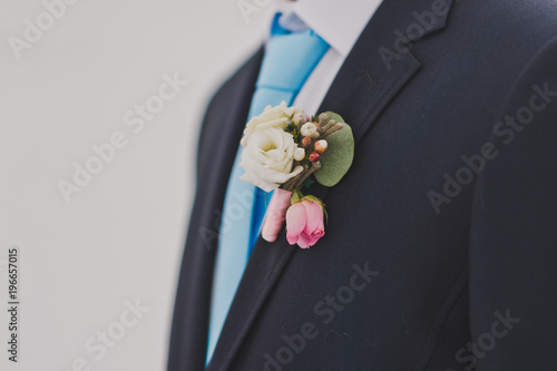 A large photo of a boutonniere on the lapel of a jacket 724.