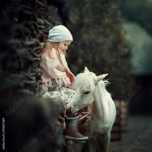 Canvas Print a little girl with a mini horse