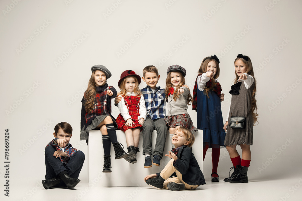 Fototapeta premium The group of beautiful girls and boys on a pastel background