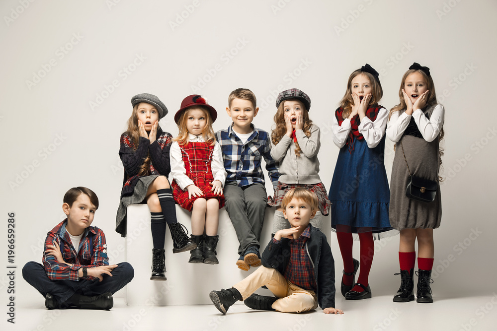 Fototapeta premium The group of beautiful girls and boys on a pastel background