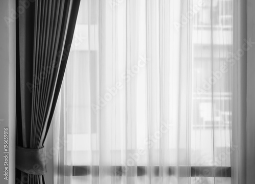 Glass window with white translucent curtain