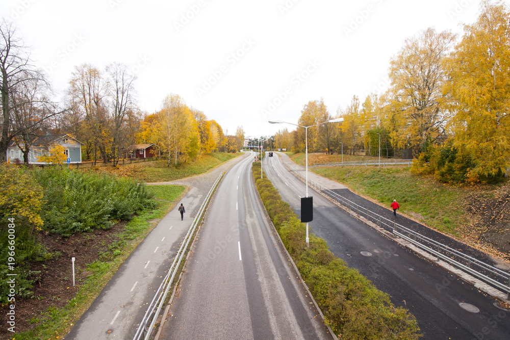 An autumn road in Finland, top view. An autumn road in Finland, top view.