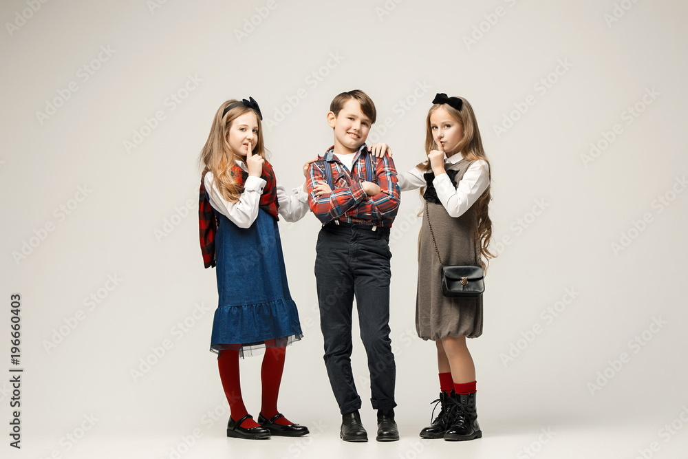 Cute stylish children on white studio background Cute stylish children on white studio background