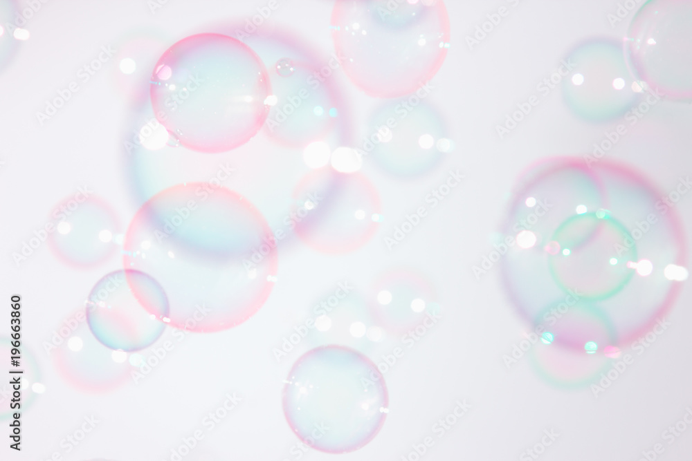 Beautiful pink soap bubbles float in the air.