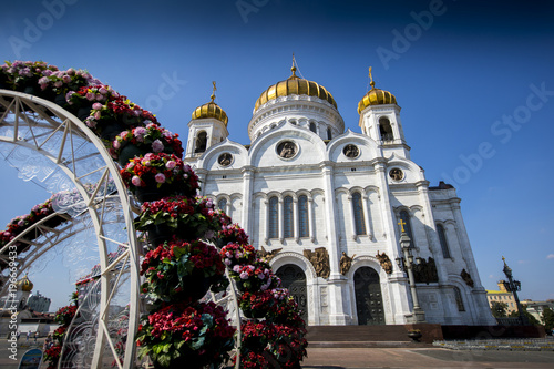 The sun shines brightly upon the Cathedral of Christ our Savior in Moscow, Russia, situated on the banks of the Moscow River.