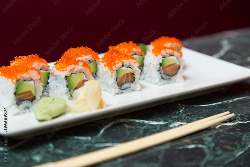 Tray of maki sushi with avocado, salmon and caviar Tray of maki sushi with avocado, salmon and caviar