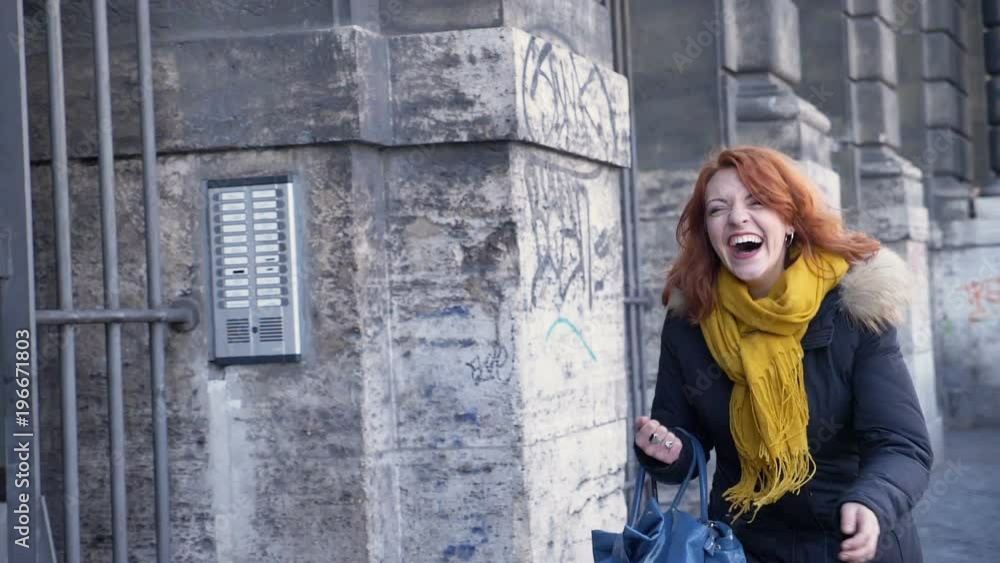Laughing pretty woman running towards camera in the street- slow motion Laughing pretty woman running towards camera in the street- slow motion