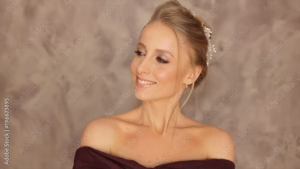 Portrait of a model with a burgundy scarf on a gray background Portrait of a model with a burgundy scarf on a gray background