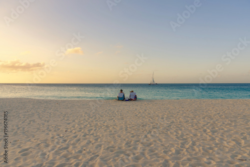 People relax and have fun during a caribbean sunset in Aruba.