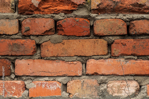 Old wall with red bricks close-up