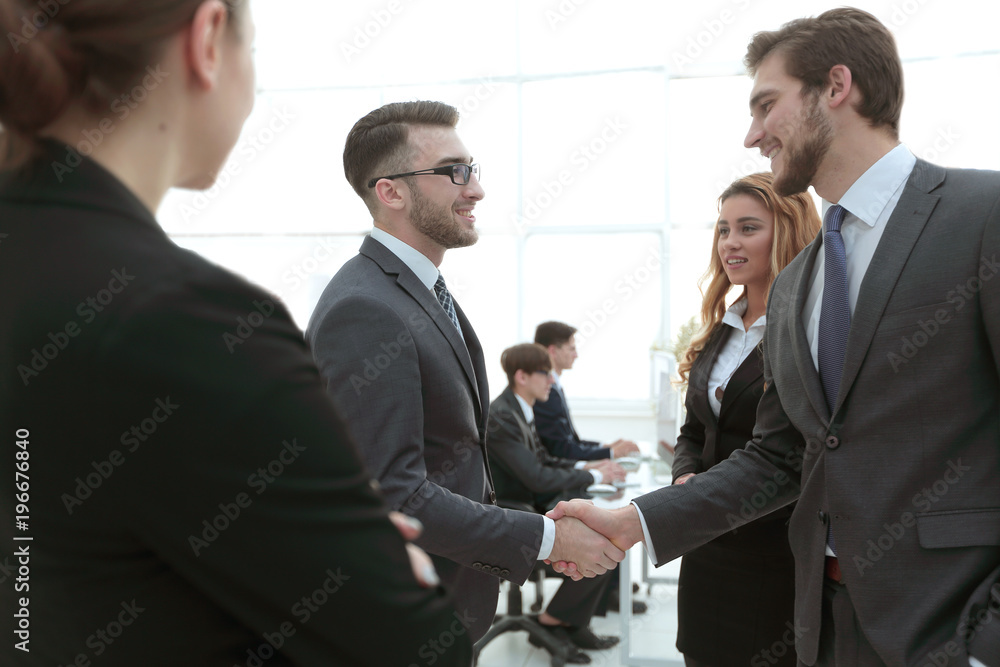 handshake business partners in the office