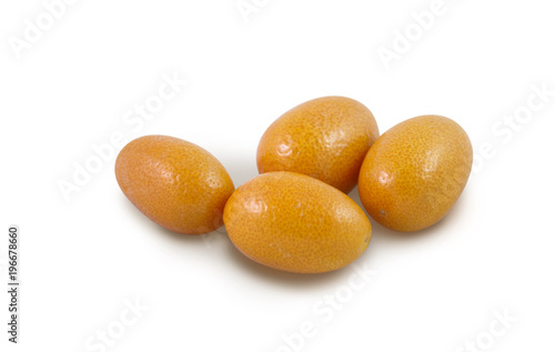 Four fresh organic kumquats on a white background
