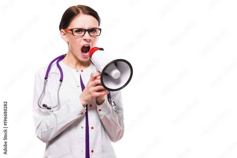Young beautiful female doctor holding tablet in her hands speak in megaphone on white background Young beautiful female doctor holding tablet in her hands speak in megaphone on white background