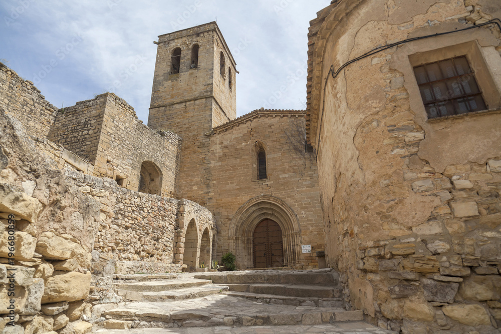  Old street view, ancient buildings and church, medieval village of Guimera, Province Lleida, Catalonia, Spain.