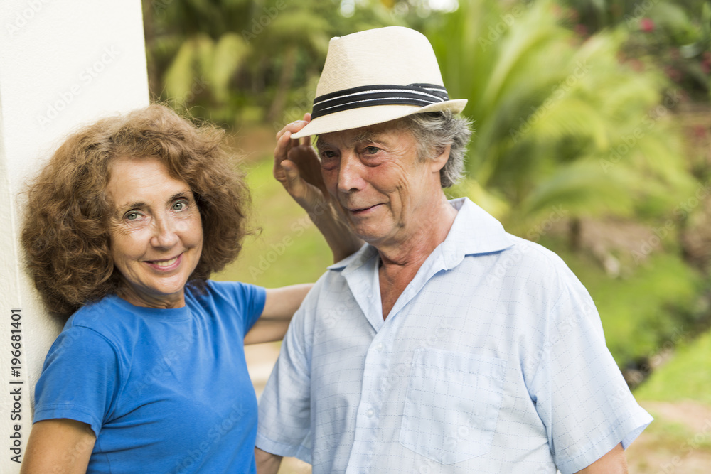 Obraz premium Portrait of a beautiful elderly couple standing embracing outdoors