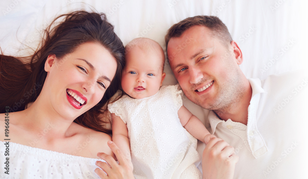 portrait of happy young mother and father with newborn baby girl portrait of happy young mother and father with newborn baby girl