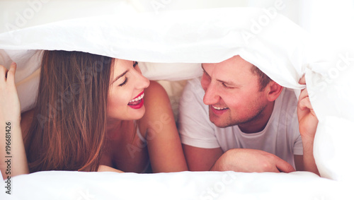 happy couple under the sheets, intimacy