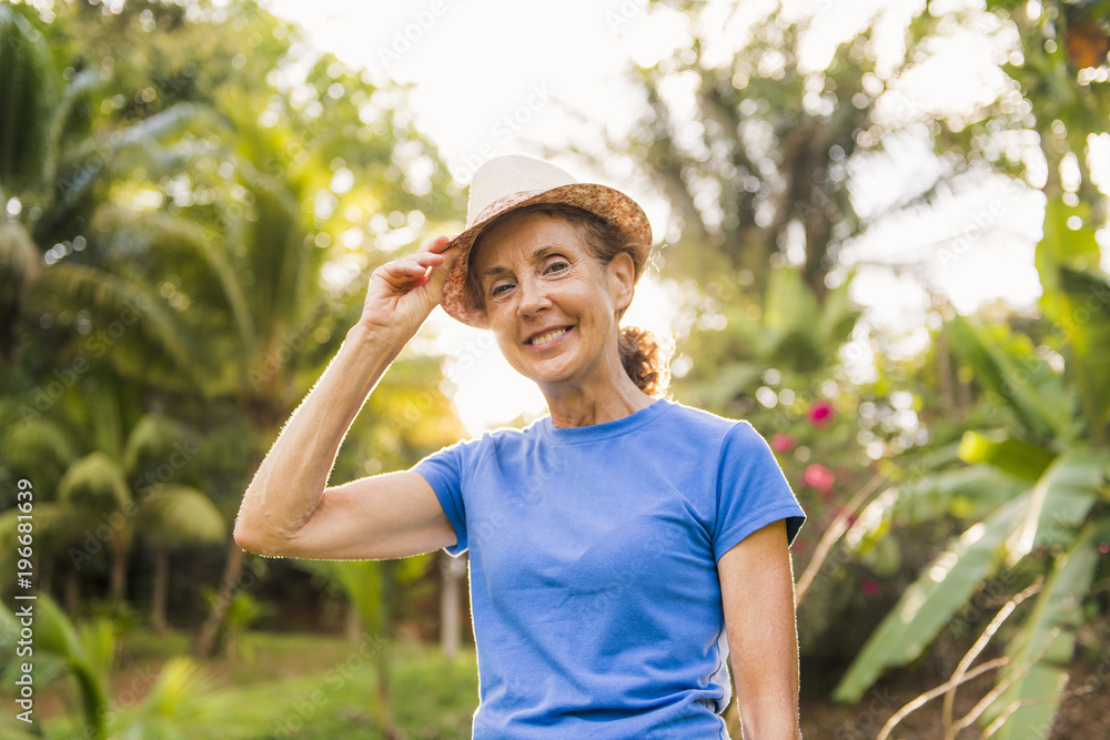 Obraz premium portrait of an older woman outside his house on the warm center equator