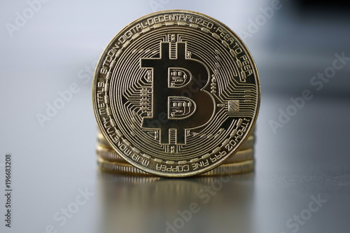 Golden Bitcoin facing the camera in sharp focus, close-up