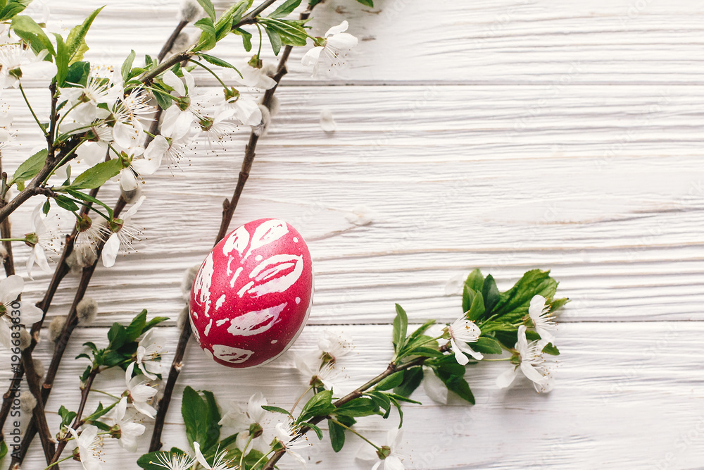 stylish Easter flat lay. painted egg on rustic wooden background with spring flowers and willow branches. happy easter greeting card. space for text. modern colorful easter eggs stylish Easter flat lay. painted egg on rustic wooden background with spring flowers and willow branches. happy easter greeting card. space for text. modern colorful easter eggs