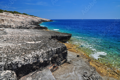 Blue sea and rocky coastline on Vis, Rukavac, Croatia photo