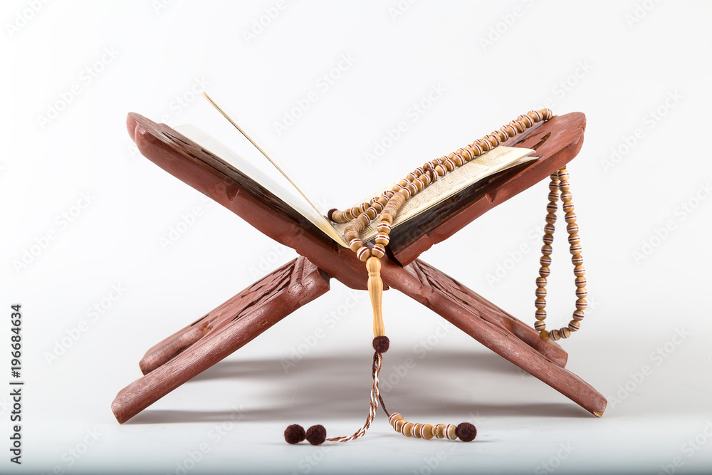 the holy book and rosary on the lectern. quran and rosary. muslim's holy book. the holy book and rosary on the lectern. quran and rosary. muslim's holy book.