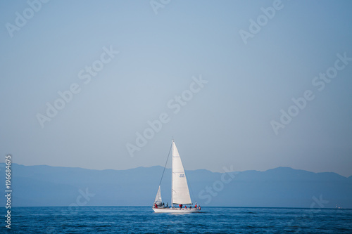 Sailboat in an international yacht race on open water photo