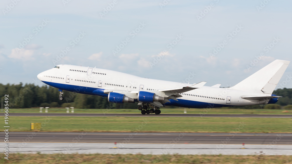 Passenger airplane fly up over take off runway from airport in summer, side view. Vacation, aviation, travel concept Passenger airplane fly up over take off runway from airport in summer, side view. Vacation, aviation, travel concept