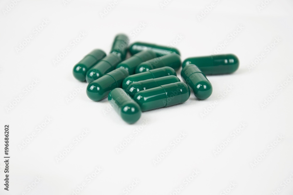 Green capsules isolated in the pharmacy laboratory Green capsules isolated in the pharmacy laboratory