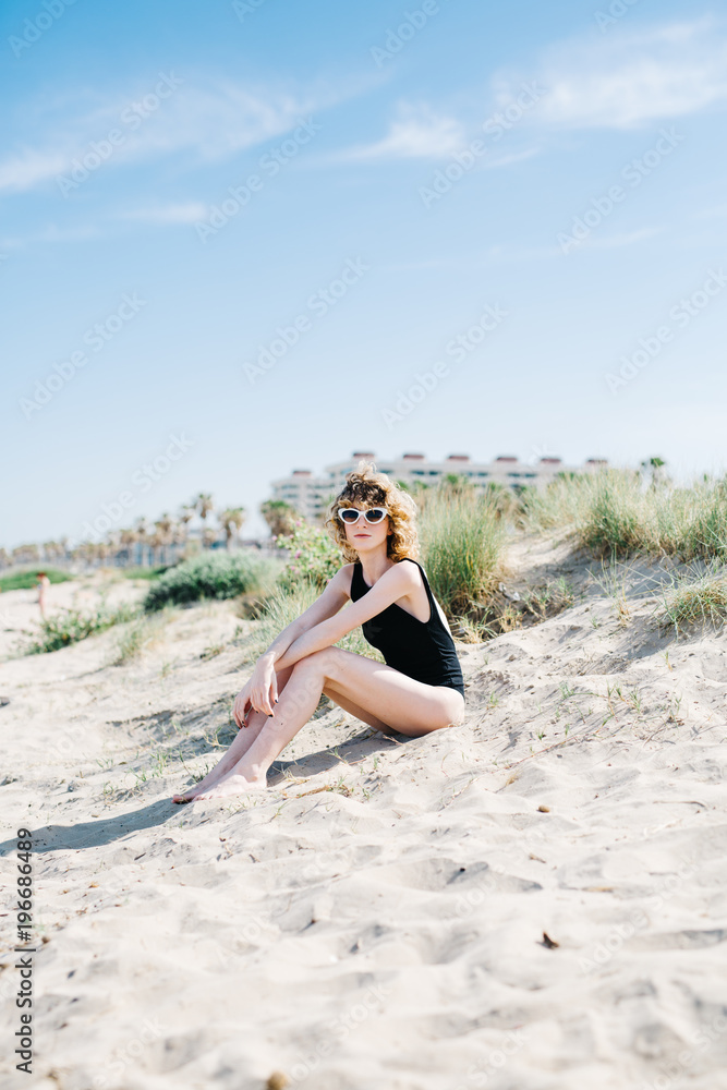 Attractive woman sitting on sand Attractive woman sitting on sand