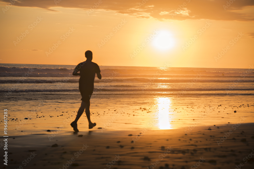 Jogger on a beach at sunset silouhaite Jogger on a beach at sunset silouhaite