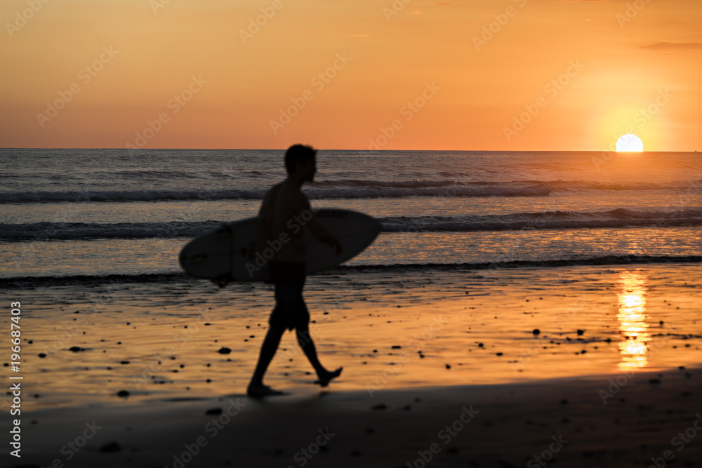 Surfer watching the waves at sunset in Costa Rica